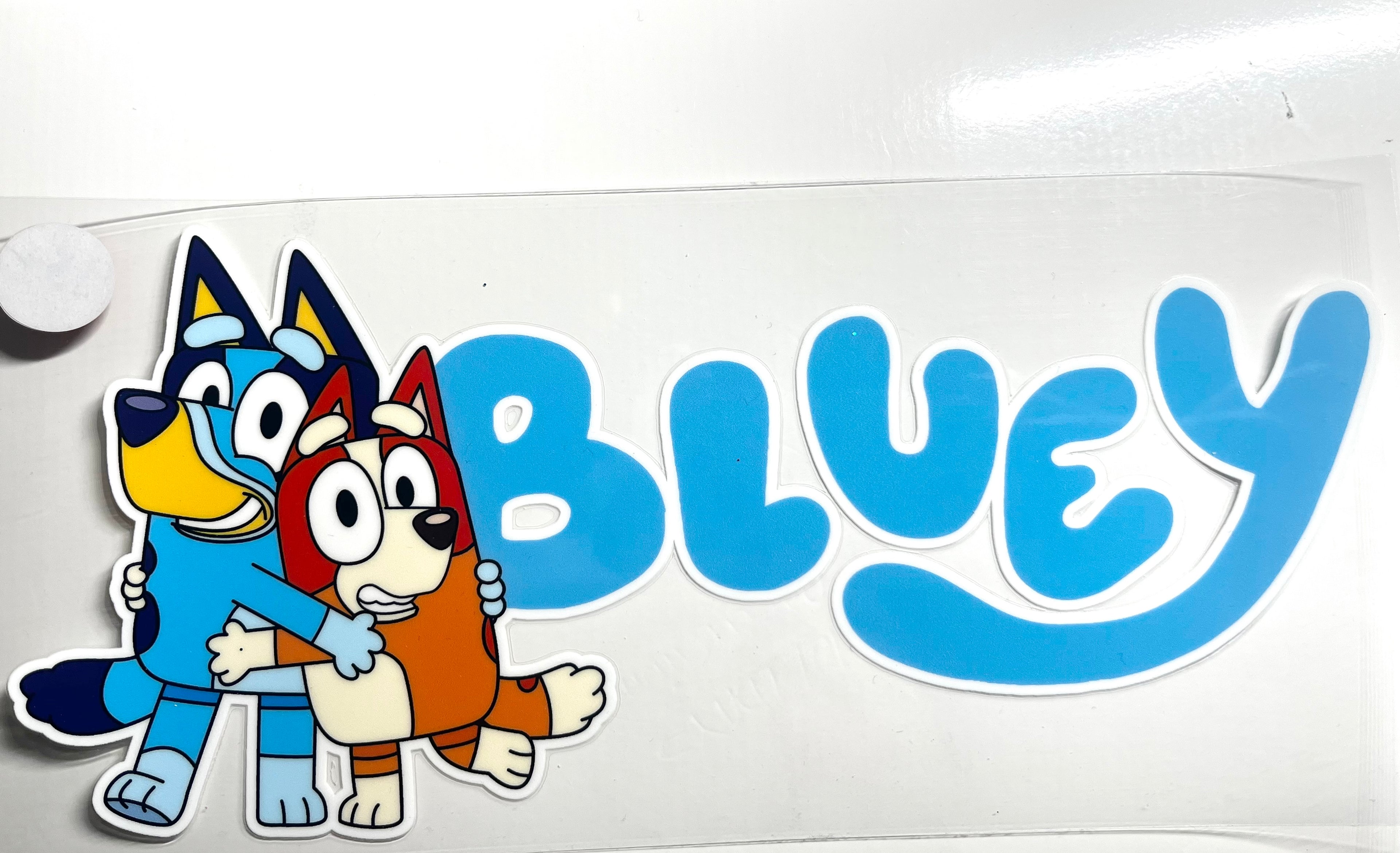 Bluey and Bingo hugging with Bluey logo decal